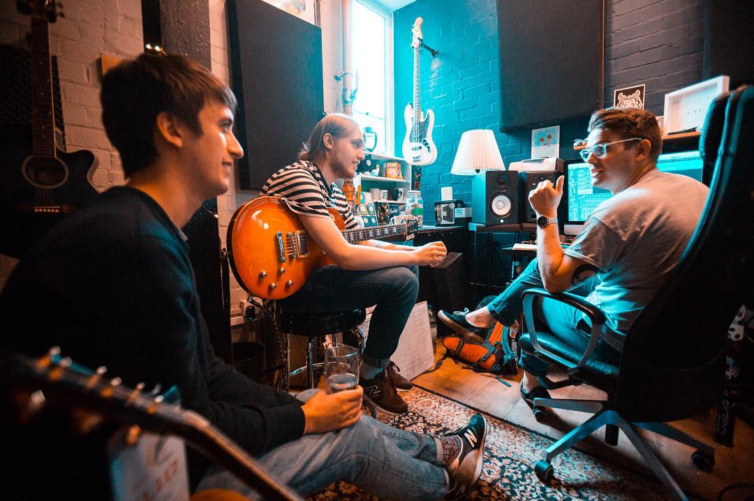 Discussing guitar parts in the studio